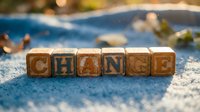 Wooden letter blocks spelling CHANGE arranged on blue surface with blurred swimming pool background. Concept for personal growth and transformation.