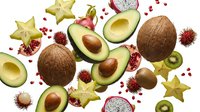 Tropical exotic fruits collection with avocado coconut dragon fruit star fruit kiwi and rambutan scattered on white background for healthy eating concepts.