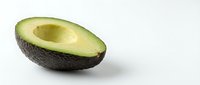 Fresh avocado half with pit removed, isolated on white background, ready for culinary, nutrition, and healthy eating design projects.