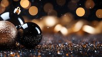 Festive black and copper Christmas baubles on glittery surface with soft bokeh lights creating magical holiday atmosphere against dark background.