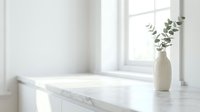 Minimalist white marble countertop with eucalyptus in ceramic vase by bright window, ideal for home decor and interior design projects.