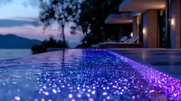 Luxurious infinity pool edge illuminated with purple lights against twilight sky and mountain silhouette, creating magical ambiance at resort villa.