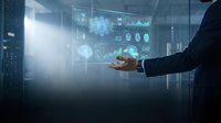 Businessman hand holding glowing digital hologram with data analytics charts, graphs and brain icon for artificial intelligence technology and business intelligence solutions.
