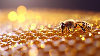 Honeybee collecting pollen on golden surface with warm bokeh background, suitable for nature, agriculture, and apiary-related projects.
