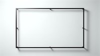 Minimalist black metal rectangular frame hanging on a white wall, modern industrial design with clean lines and simple structure.