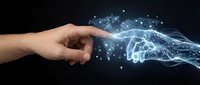 Human hand reaching toward glowing digital hand with network connections representing AI technology, artificial intelligence, and human-machine interaction on dark background.