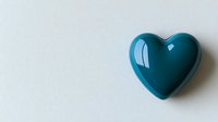 Glossy teal heart shape on white background casts subtle shadow, minimalist romantic symbol for love, wellness and healthcare concepts.