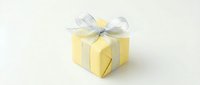 Yellow gift box with silver ribbon bow on white background, elegant present for holiday, birthday, or celebration occasion.