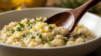 Creamy risotto with fresh herbs and wooden spoon in white bowl, perfect for cooking blogs, food websites, restaurant menus, and culinary publications.