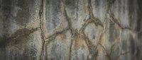 Cracked concrete wall texture with weathered surface showing natural aging patterns and structural damage for industrial design backgrounds.