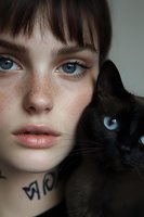Close-up portrait of young woman with freckles and blue eyes posing with black cat. Matching eye colors create striking visual connection. Neck tattoo adds edgy detail.