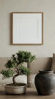 Minimalist living room with empty wooden frame mockup, bonsai tree, and rustic ceramic vase on neutral beige background for art display.