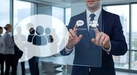Professional businessman in suit touching digital interface with team icons and chat symbols in modern office environment for business communication concepts.