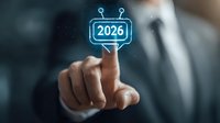 Businessman pointing at glowing blue 2026 number in futuristic speech bubble interface, representing business planning and future technology concept.