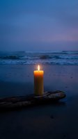Burning candle on driftwood at twilight beach with ocean waves creating peaceful meditation atmosphere for relaxation and spiritual wellness concepts.