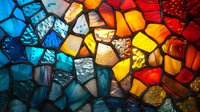 Vibrant stained glass mosaic pattern with irregular shapes in blue, orange, red, and yellow tones creating an abstract artistic composition with light shining through.