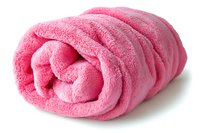Rolled pink fluffy towel on white background, soft terry cloth textile with folds and shadows, isolated spa and bathroom accessory for wellness and hygiene.
