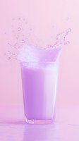 Dynamic splash of pink milk or smoothie in tall glass against pastel background, creating energetic liquid motion with droplets and waves in soft lighting.