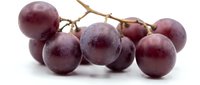 Fresh red grapes cluster on white background, isolated ripe fruit bunch with natural bloom, perfect for food, nutrition, and healthy eating projects.