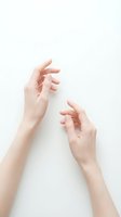 Two elegant female hands with natural manicure reaching toward each other on clean white background, isolated for design and beauty concepts.