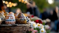 Decorated Easter eggs with traditional folk patterns in wicker basket alongside spring daisies, festive bokeh lights create magical holiday atmosphere.
