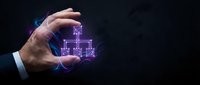 Businessman hand holding glowing purple digital network structure with interconnected nodes on dark background for technology and business solutions.
