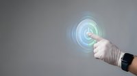 Hand in medical glove pointing at holographic digital interface with circular waves, futuristic healthcare technology concept for medical presentations.