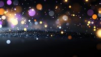 Magical glowing bokeh lights floating over dark glittery surface create dreamy atmospheric background with purple and golden orbs of light for festive designs.