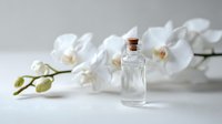 Small glass bottle with cork stopper next to elegant white orchid flowers on light background, creating serene spa or wellness atmosphere.