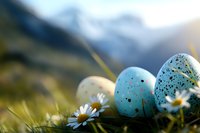 Speckled blue Easter eggs nestled in spring grass with white daisies against blurred mountain landscape background, creating seasonal holiday atmosphere.