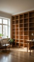 Modern home office interior with built-in wooden bookshelf wall and mid-century furniture creating organized workspace for productivity and reading.