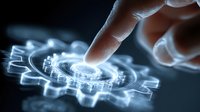 Hand touching glowing digital gear mechanism with circuit patterns on dark background representing technology innovation and industrial automation concepts.