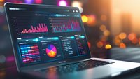 Business analytics dashboard on laptop screen showing colorful charts, graphs and data visualization for financial reporting and market analysis.