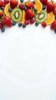 Fresh mixed fruits border with strawberries, blueberries, kiwi and orange slices on white background with copy space for healthy eating concepts.