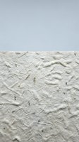 Handmade white paper texture with natural fibers and organic elements for craft projects and artistic backgrounds.