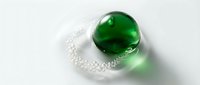 Green glass marble with clear twisted stem on white background isolated for design projects and decorative concepts.