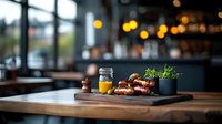 Gourmet breakfast setting with fresh orange juice, croissants and microgreens on wooden serving board in cozy restaurant atmosphere with bokeh lights.