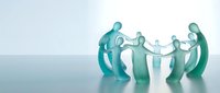 Translucent teal figures holding hands in circle formation on reflective surface representing teamwork, unity, collaboration and community support concepts.