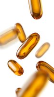 Golden omega-3 fish oil capsules floating on white background, dietary supplements for health and wellness, vitamin pills isolated for medical design.