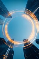 Dynamic circular light trails against modern skyscrapers and blue sky, creating futuristic motion effect for business and technology concepts.