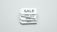 White sale price tags stacked together showing discount percentages, minimal retail concept on light gray background for shopping promotions.