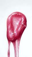 Glossy pink lollipop with sparkling sugar coating and shiny finish against white background, suitable for candy, confectionery, and food product marketing.