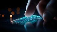 Glowing blue powder substance touched by fingers in dark setting with bokeh lights, creating mysterious atmospheric mood for conceptual drug awareness designs.