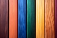 Colorful wooden planks arranged in vertical stripes showcasing different wood textures and vibrant stains from purple, orange, blue, green to yellow and natural grain patterns.