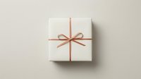 White gift box with elegant pink ribbon bow on neutral background for special occasions and celebrations.