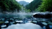 Tranquil hot spring with rising steam and smooth black rocks in mountain forest setting, low angle view across misty water surface creates serene atmosphere.