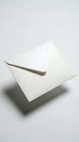 White paper envelope floating above light surface, casting soft shadow, symbolizing mail, correspondence, and communication concepts.