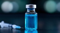 Medical vial with blue liquid and syringe on dark background with bokeh effect, pharmaceutical research and vaccination concept for healthcare industry.