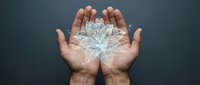 Cupped hands holding glowing lotus flower symbol representing mindfulness, meditation, spiritual growth, wellness and inner peace concepts.
