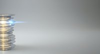Stacked coins with glowing blue laser beam emerging from top, symbolizing financial growth, energy efficiency, and business innovation on neutral background.